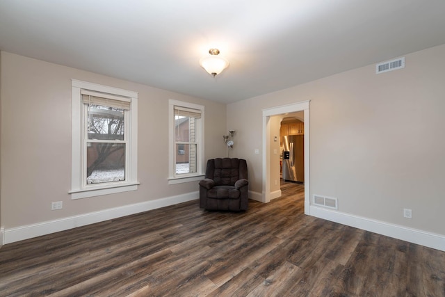 unfurnished room with dark hardwood / wood-style flooring