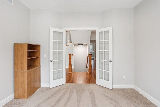 carpeted empty room with french doors