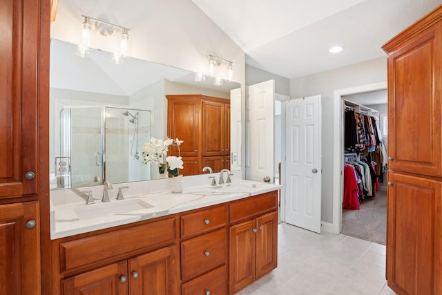 bathroom featuring vaulted ceiling, vanity, tile patterned floors, and walk in shower