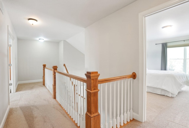 hallway featuring light carpet