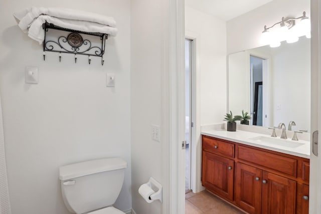 bathroom with tile patterned floors, vanity, and toilet