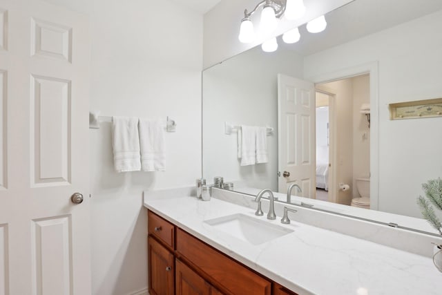 bathroom with vanity and toilet