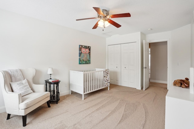 bedroom with ceiling fan, carpet floors, and a closet