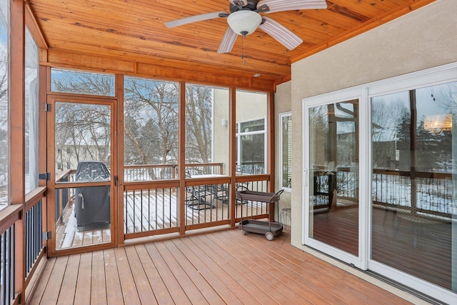 unfurnished sunroom with wooden ceiling and ceiling fan