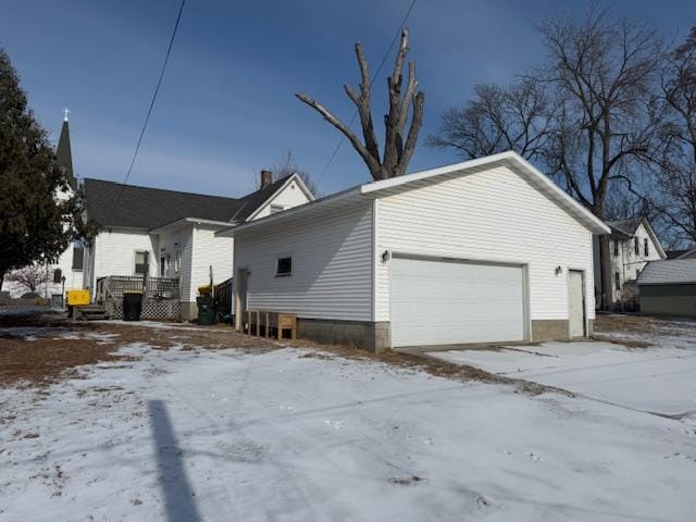 snow covered property featuring a garage