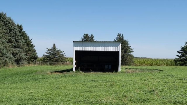 view of outbuilding with a yard and a rural view