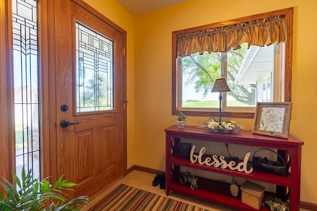 foyer featuring light tile patterned floors and plenty of natural light