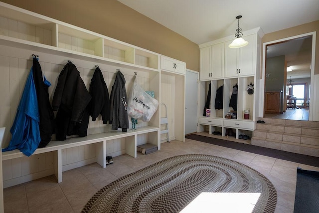 mudroom featuring vaulted ceiling and light tile patterned floors