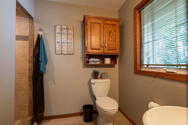 bathroom featuring tile patterned flooring and toilet