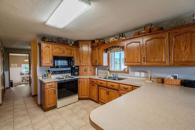 kitchen featuring light tile patterned flooring, white electric range, sink, and a textured ceiling