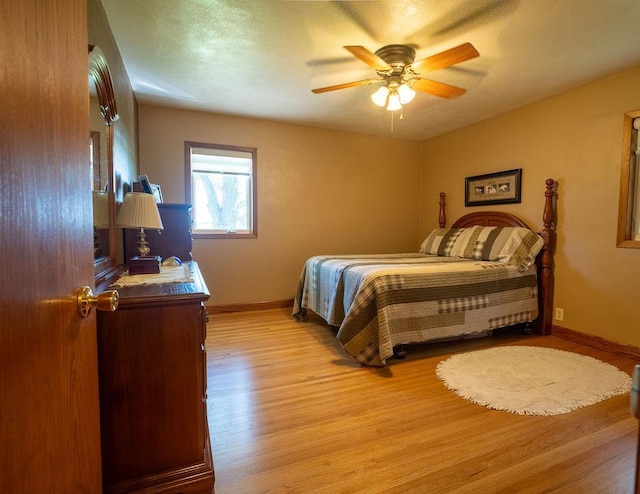 bedroom with ceiling fan and light hardwood / wood-style flooring