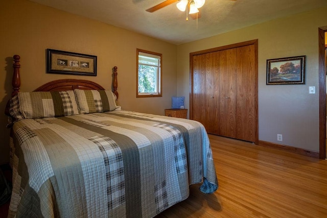 bedroom featuring hardwood / wood-style flooring, a closet, and ceiling fan