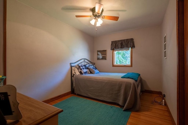 bedroom featuring hardwood / wood-style flooring and ceiling fan