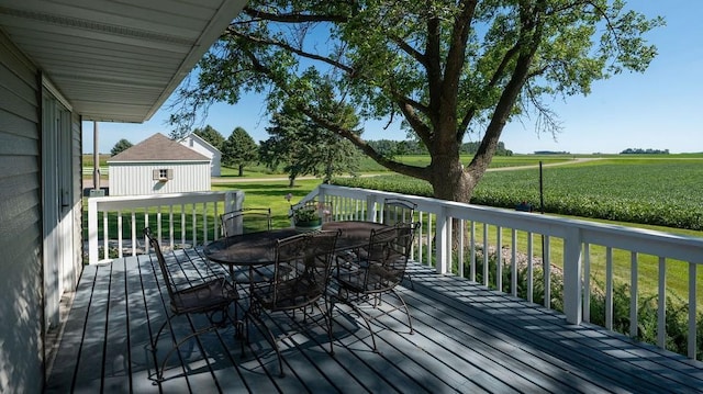 wooden terrace featuring a lawn