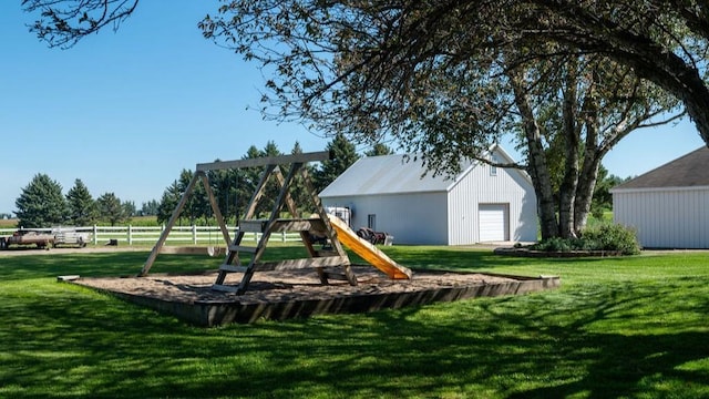 view of jungle gym with an outdoor structure and a lawn