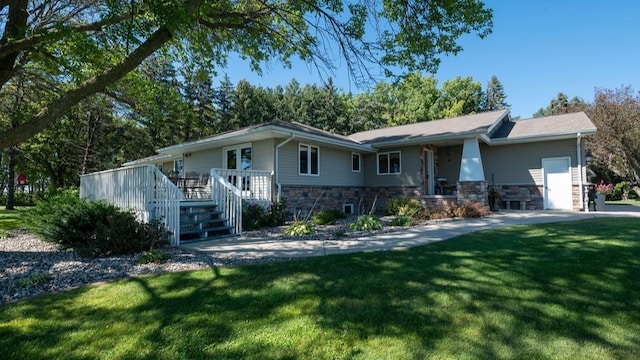 ranch-style house featuring a garage and a front lawn