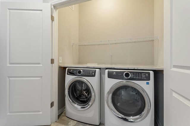 washroom with washer and dryer