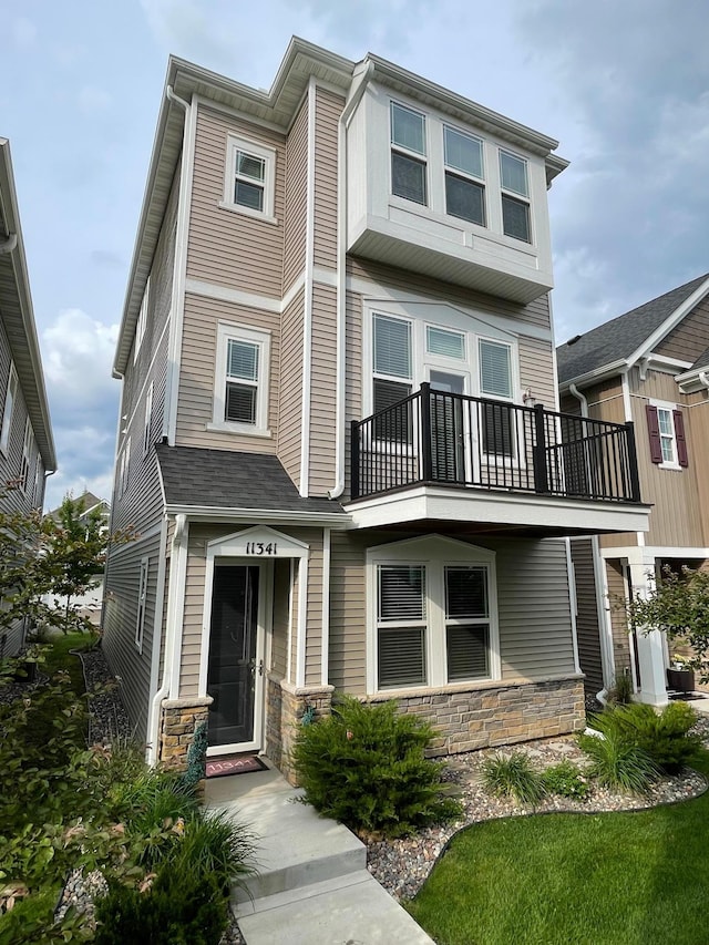 11341 81st Way N, Maple Grove, MN 55369 - view of front of home with a balcony and stone siding