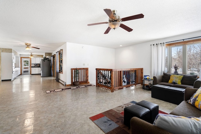 living room with a textured ceiling, a ceiling fan, and plenty of natural light
