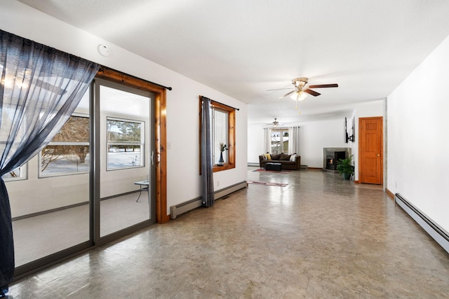 unfurnished room featuring baseboards, baseboard heating, and a ceiling fan
