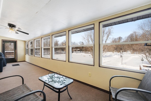 sunroom / solarium with baseboards, carpet flooring, lofted ceiling, and a ceiling fan