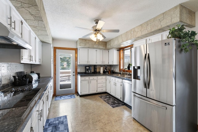 kitchen featuring a sink, a ceiling fan, under cabinet range hood, stainless steel appliances, and white cabinets