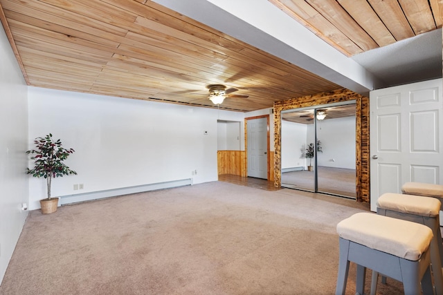 unfurnished room with carpet flooring, ceiling fan, wood ceiling, and a baseboard radiator