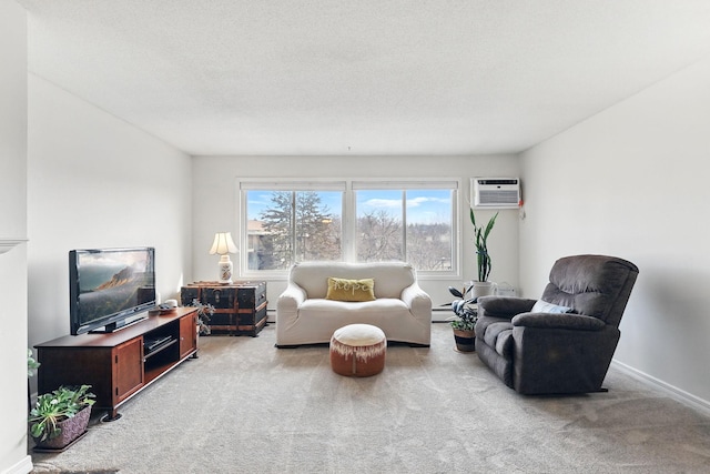 living area with a wall unit AC, baseboards, a baseboard radiator, a textured ceiling, and carpet flooring