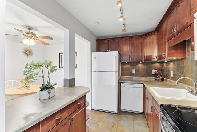 kitchen featuring white appliances, a ceiling fan, a sink, light countertops, and tasteful backsplash