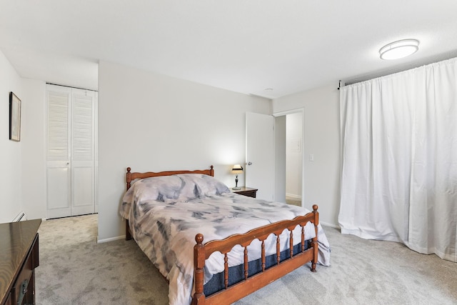 bedroom with light colored carpet and baseboards