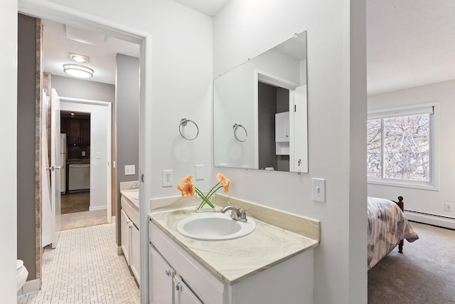 bathroom featuring baseboard heating, ensuite bath, and vanity