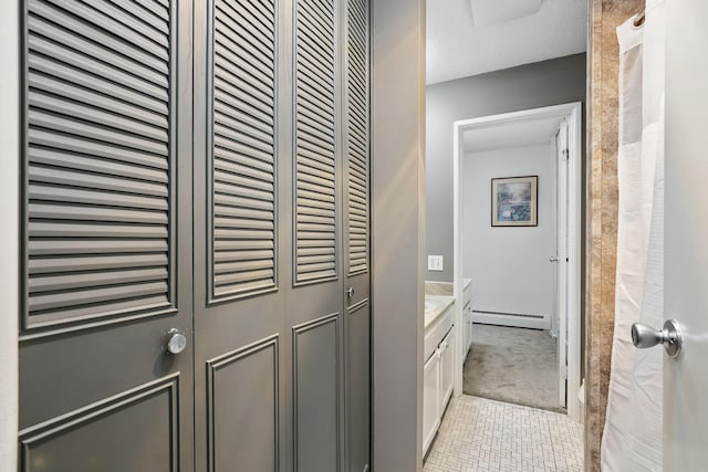 bathroom featuring baseboard heating, vanity, and tile patterned flooring