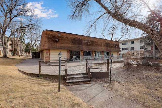 view of front of home with a wooden deck and a front yard