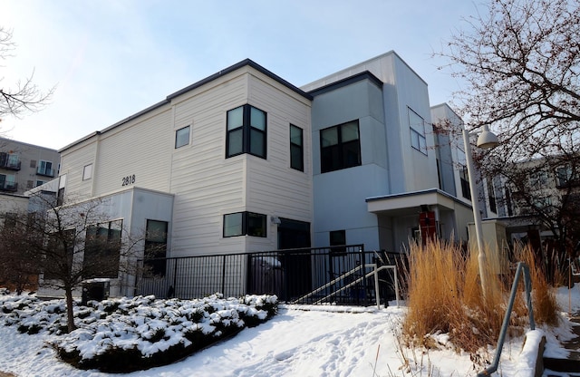 view of snow covered rear of property