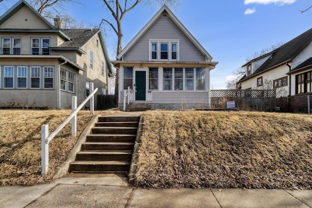 bungalow-style home featuring fence