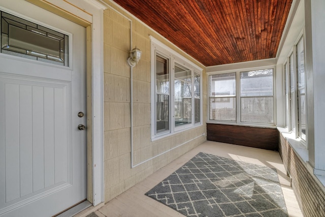 unfurnished sunroom featuring wood ceiling