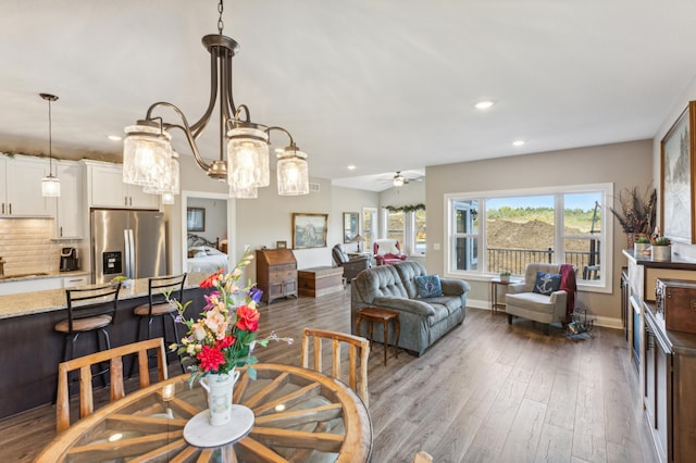 dining space featuring recessed lighting, ceiling fan, baseboards, and wood finished floors