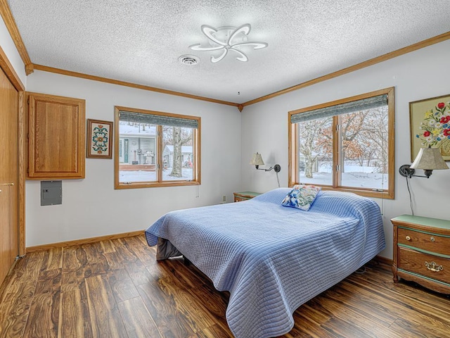 bedroom with multiple windows, ornamental molding, and dark wood-style flooring