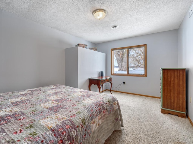 bedroom featuring baseboards, visible vents, a textured ceiling, and light colored carpet