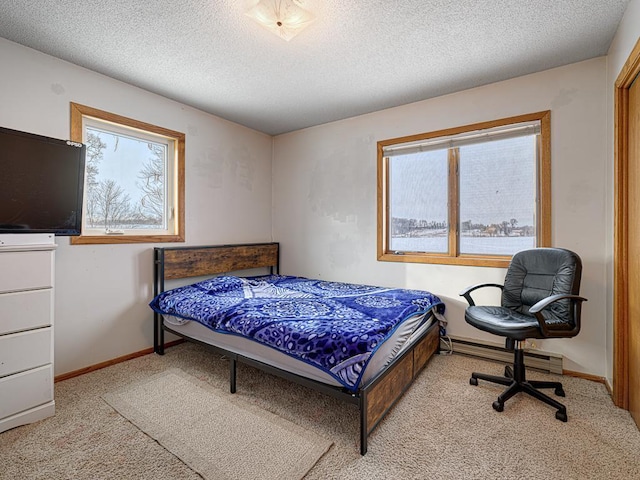 bedroom with light colored carpet, multiple windows, a textured ceiling, and baseboards