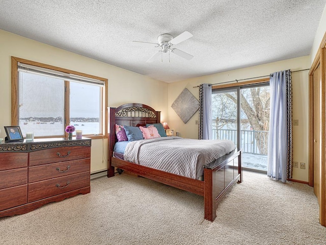 bedroom with access to outside, a textured ceiling, a ceiling fan, and light colored carpet