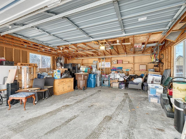 garage with metal wall and freestanding refrigerator