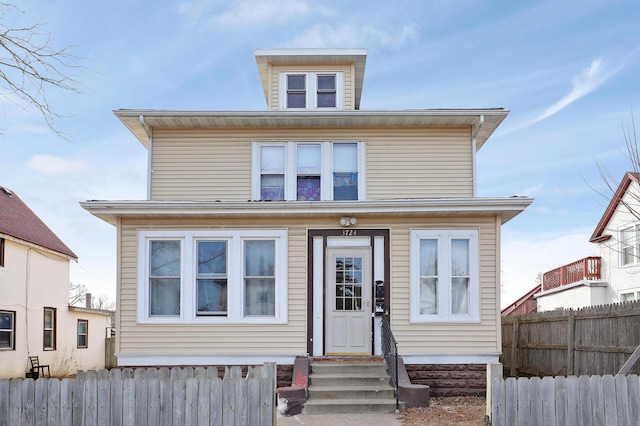 traditional style home featuring entry steps and fence