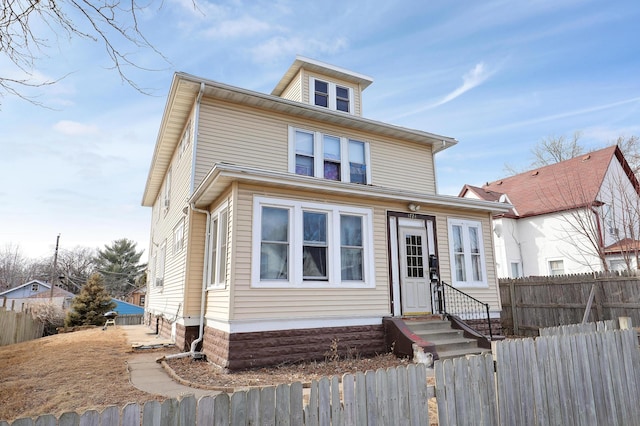 traditional style home featuring fence and entry steps