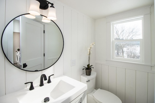 bathroom featuring washer / clothes dryer, sink, and toilet