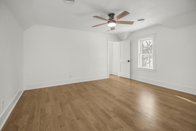 additional living space with ceiling fan, wood-type flooring, and vaulted ceiling