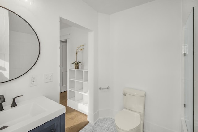 bathroom featuring vanity, toilet, and wood-type flooring