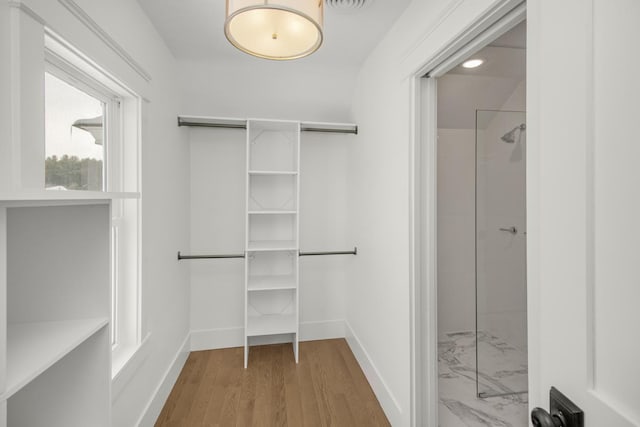 walk in closet featuring hardwood / wood-style floors