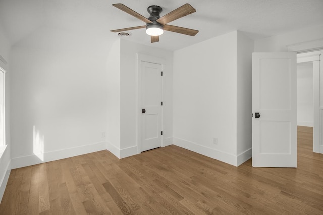 empty room with ceiling fan and light wood-type flooring