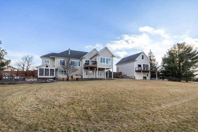 back of property with a yard and a balcony